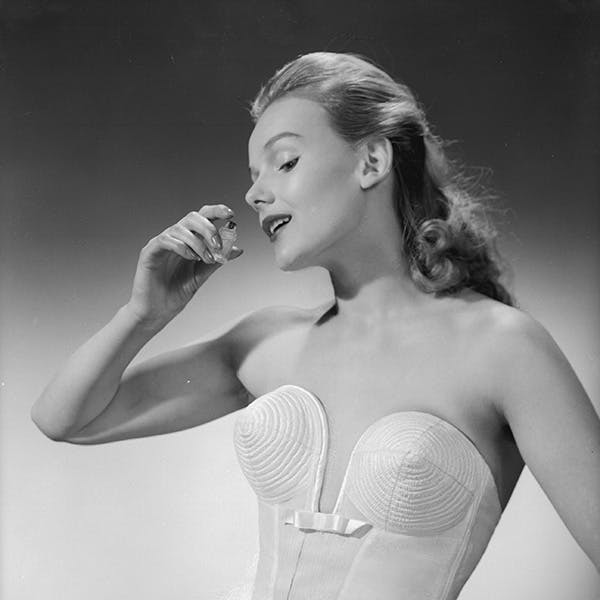 black & white;format portrait;female;bottle;perfume;fashion clothing;cha 3510-9;m/clo/1950-59/unde clothing apparel person human lingerie underwear