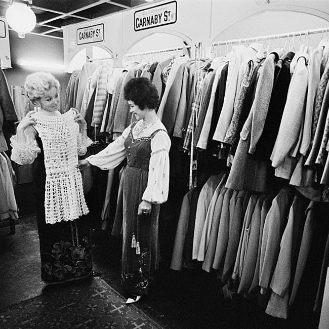 black and white photograph huty20695 1967 indoors exp 1967 - 4513 fr 9 two people only women full length clothing store clothes rack trying on london furniture person human room clothing apparel shop boutique