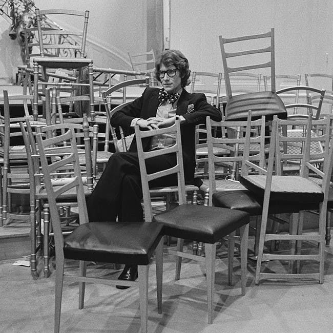 huty19859 huty 19859 black and white 1972 one man exp 1972 382 fr 20-20a huty1985911 indoors full length sitting french fashion designer large group of objects chair hands clasped furniture restaurant person human cafe cafeteria